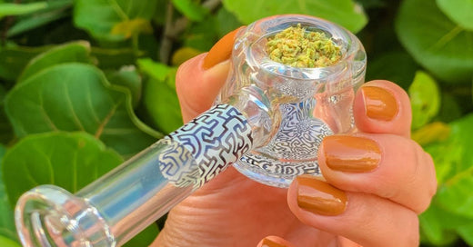 Women hand holding bowl with weed