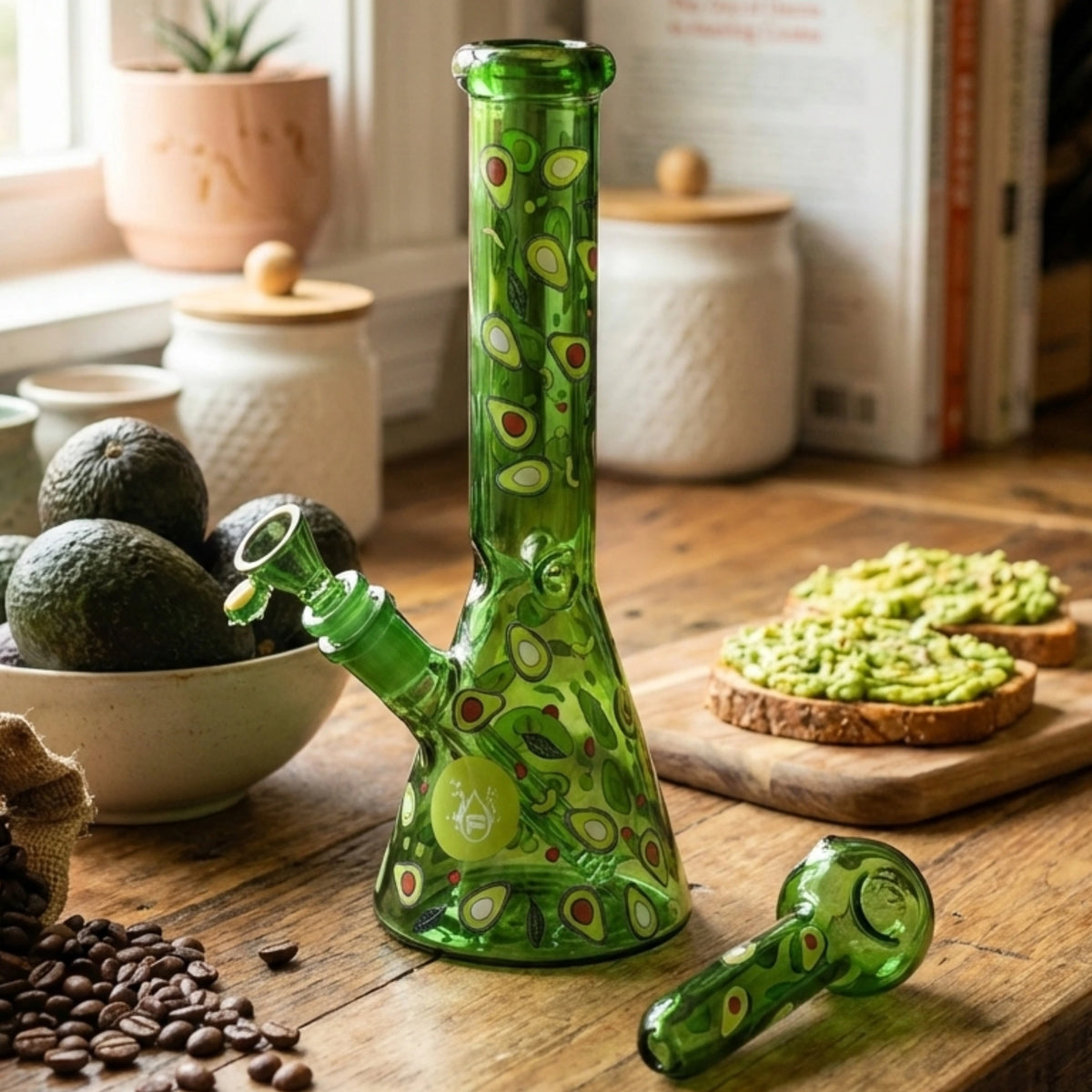 Green glass bong with avocado pattern on a wooden table with food items.