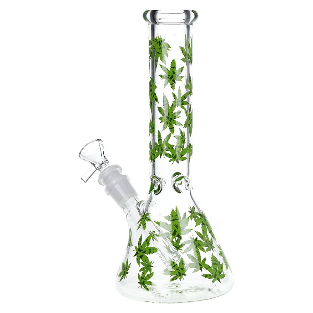 A clear glass water pipe with green cannabis leaf patterns printed all over it, shown on a solid white background.