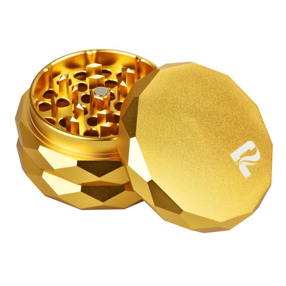 Gold metal grinder with a brand logo on a white background