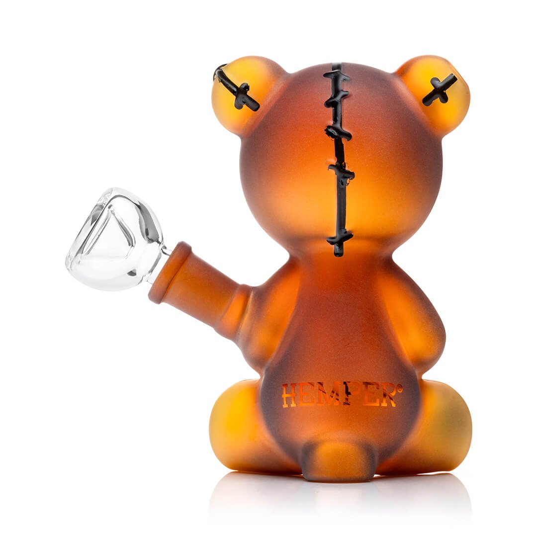 Amber-colored bear-shaped bong with a bowl on a white background