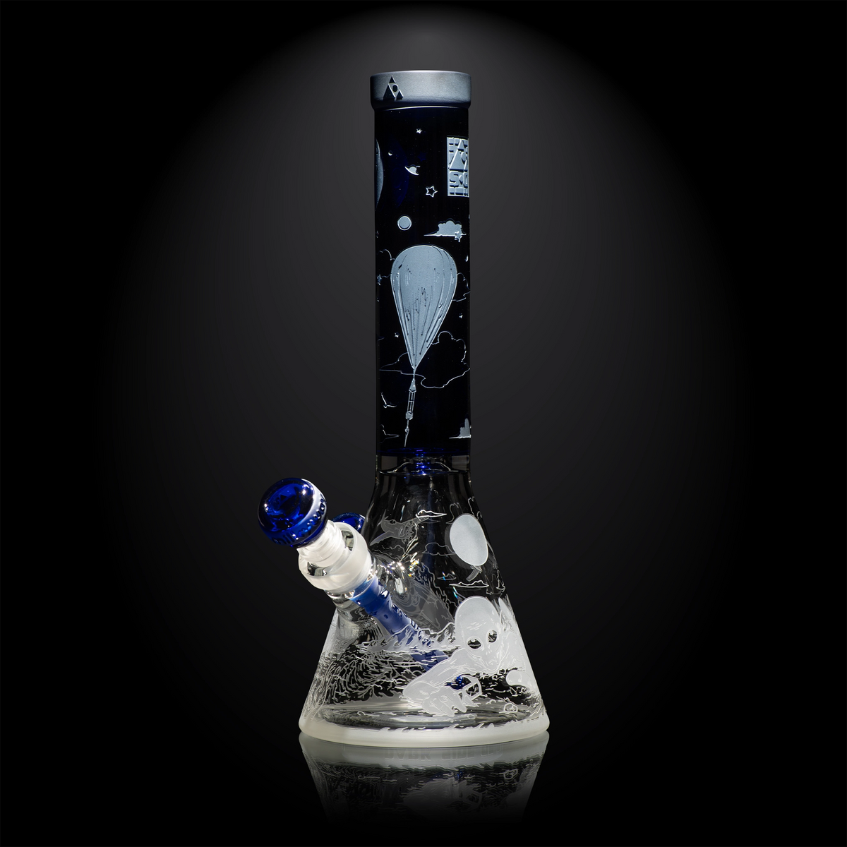 Glass water pipe with black and white design on a dark background