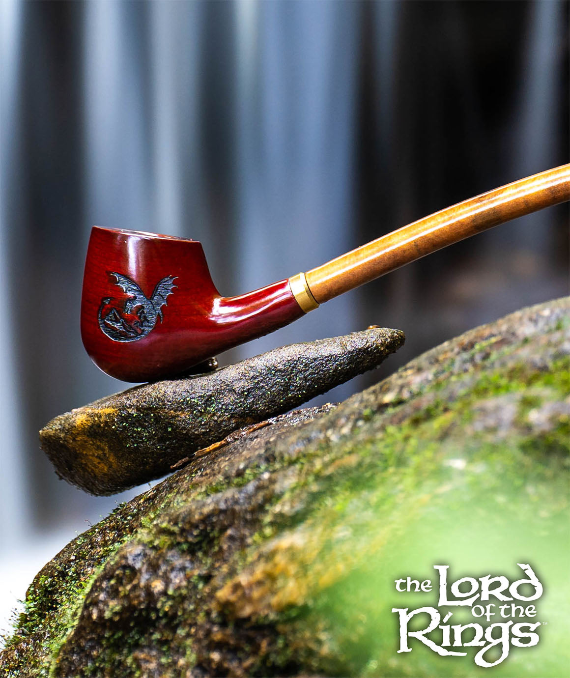Red pipe with gold accents on a stone surface, featuring 'The Lord of the Rings' logo.