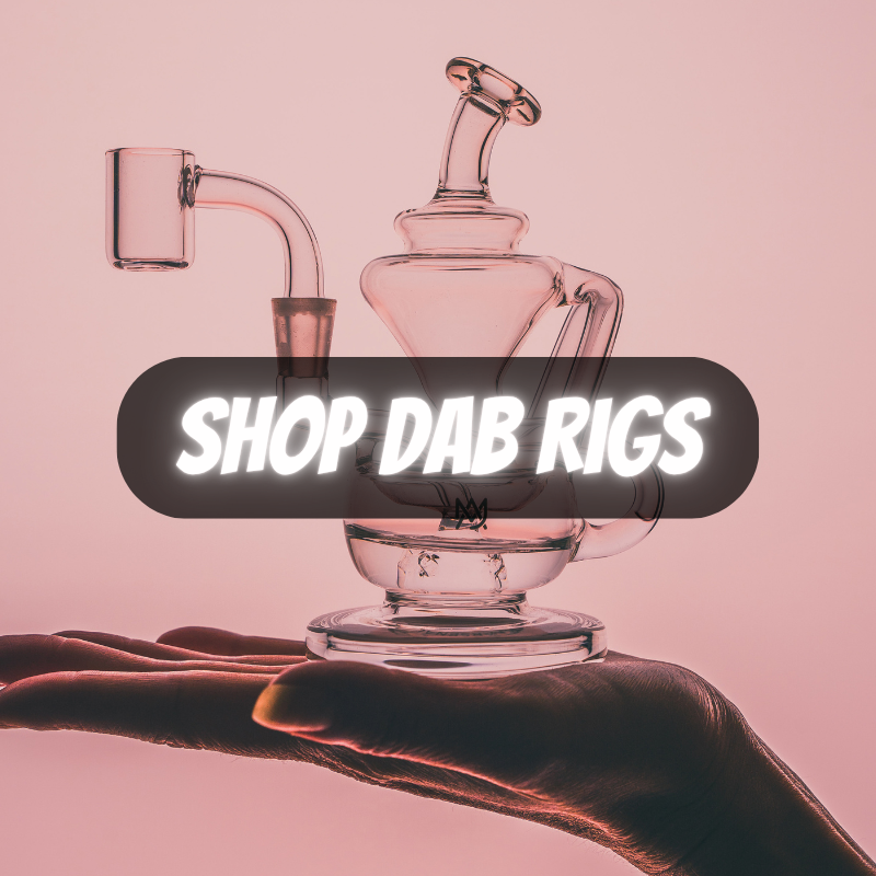 Glass dab rig held by a hand with 'Shop Dab Rigs' text on a pink background