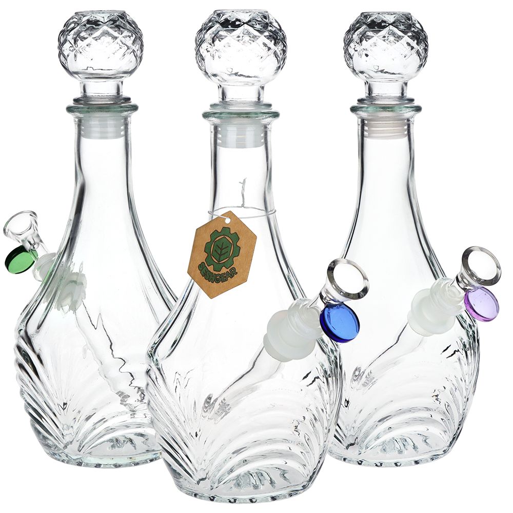 Three clear glass bongs decanters with decorative stoppers on a white background