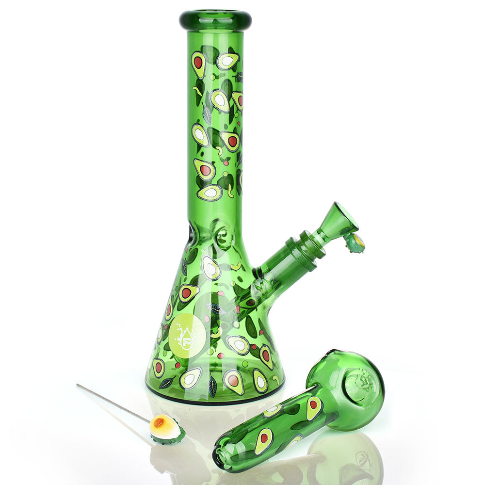 Green glass bong and spoon pipe with avocado pattern on a white background