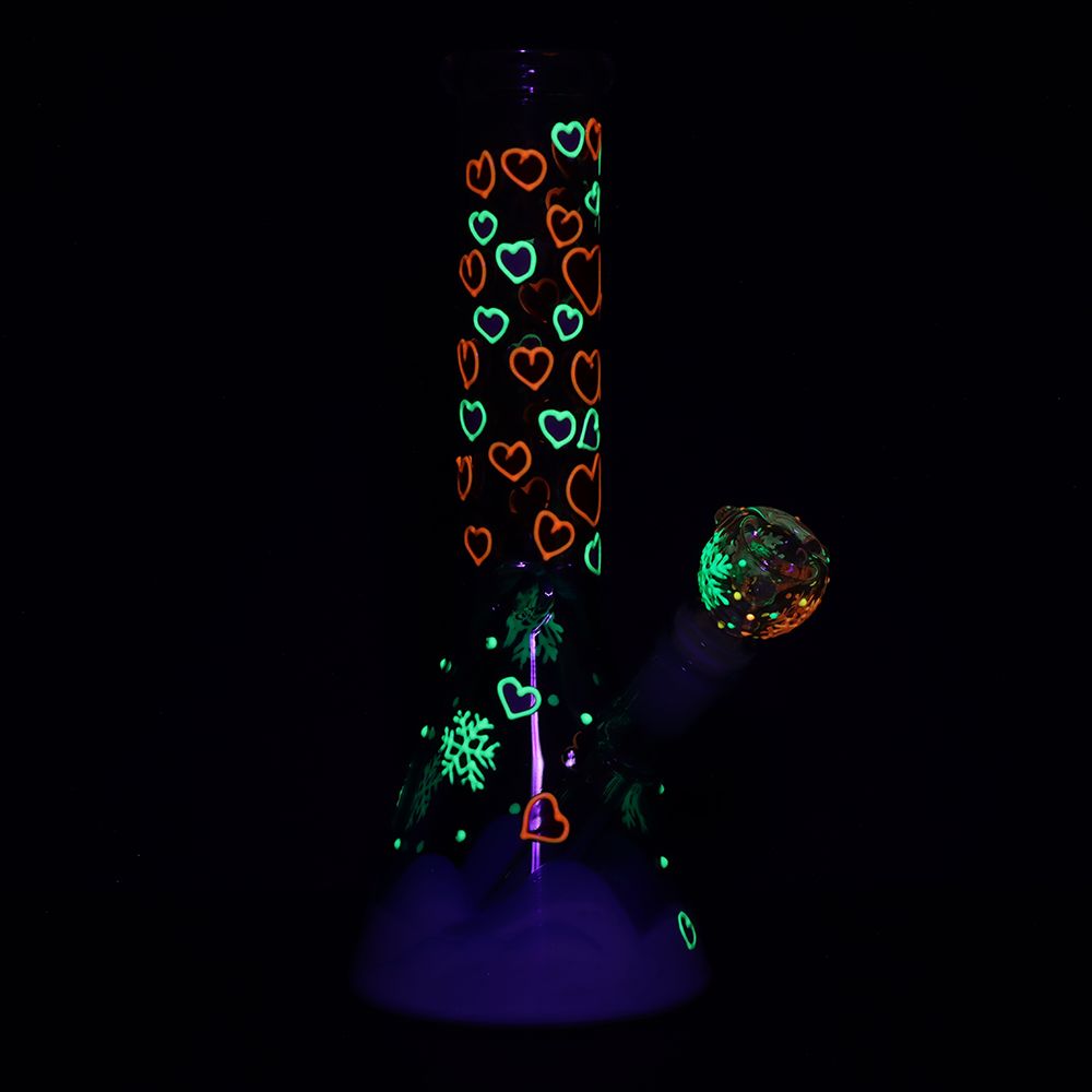 Glowing glass bong with heart patterns on a black background
