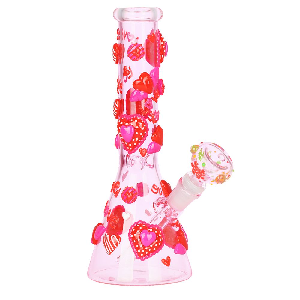 Glass water pipe with heart designs on a white background